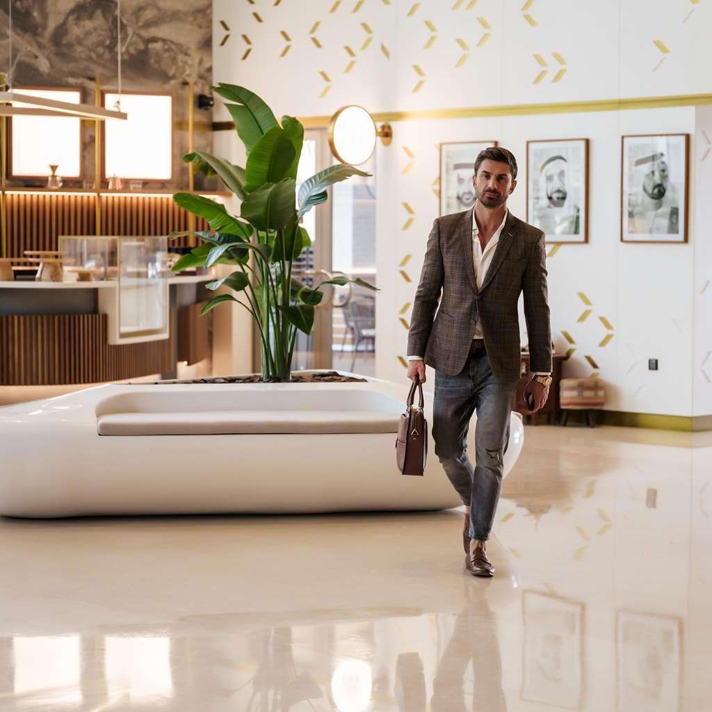 The First Collection Dubai Business Bay Hotel Interior photo A man walking through a lobby